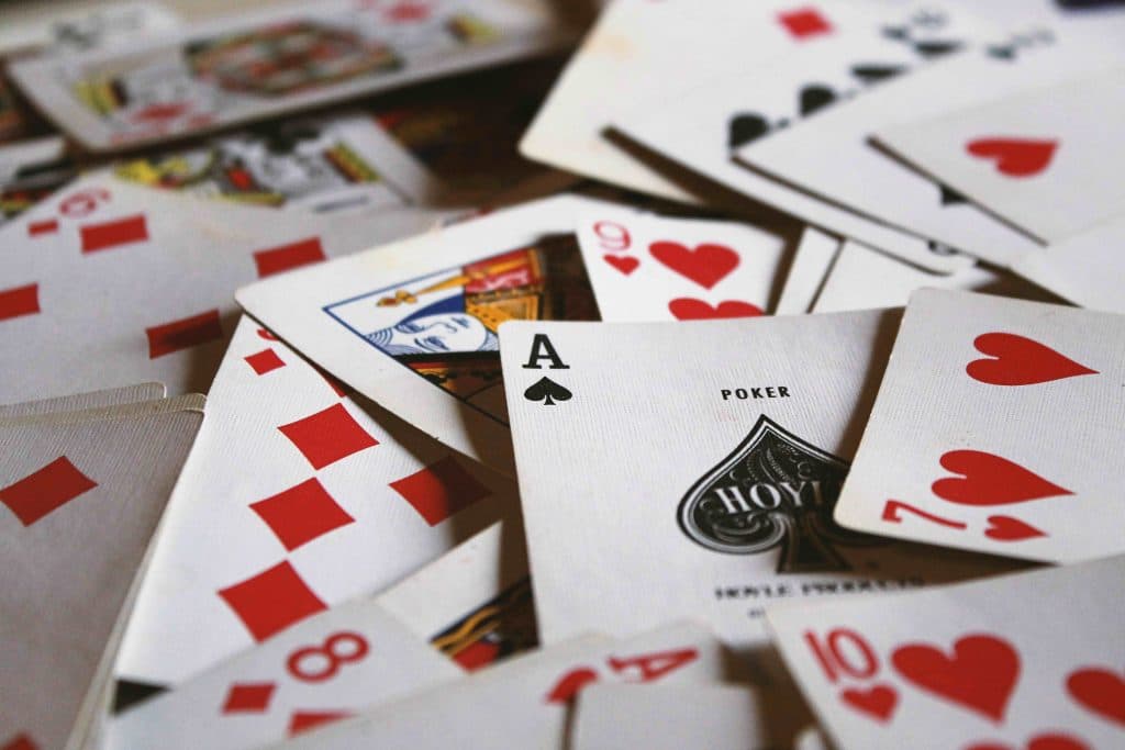A pile of playing cards, the ace of spades visible in the centre.