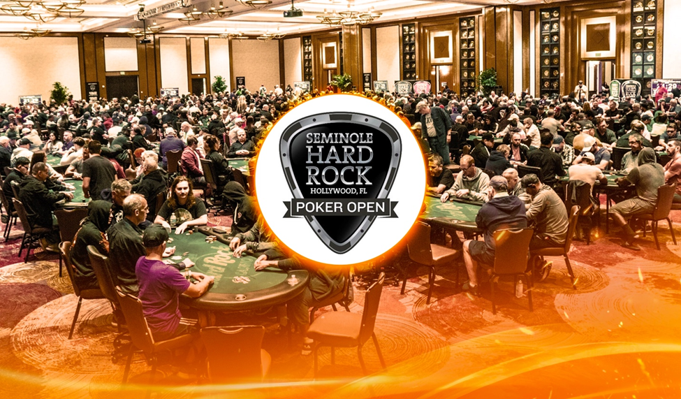 A crowded poker room during the Seminole Hard Rock Poker Open, featuring players and the event logo.