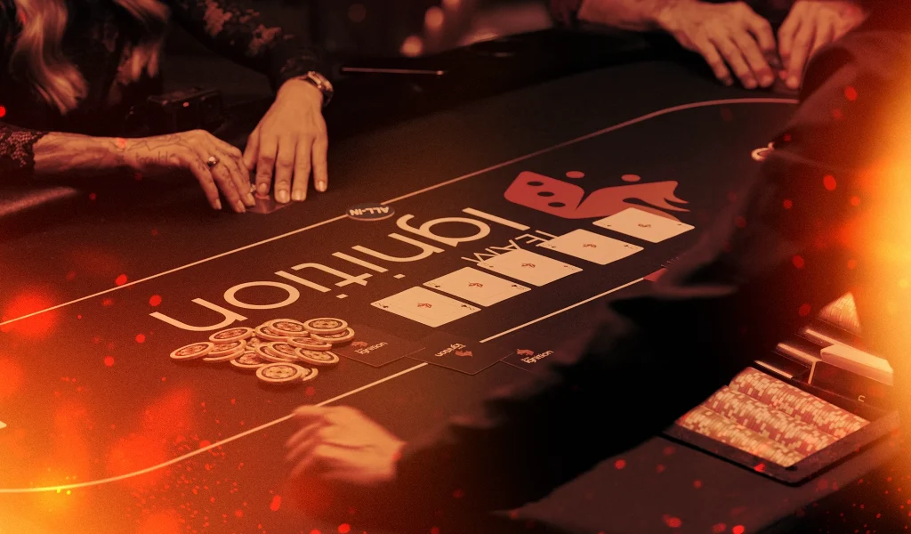 A poker table with an “Ignition” logo, players’ hands reaching for chips, and community cards laid out, with a warm, dramatic glow enhancing the scene.